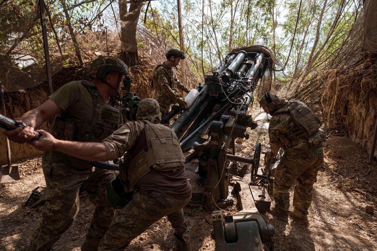 Ukrajinskí vojaci 148. delostreleckej brigády nakladajú muníciu do húfnice M777 pred streľbou na ruské pozície na fronte v regióne Záporožie na Ukrajine vo štvrtok 7. augusta 2025. Foto: TASR/AP