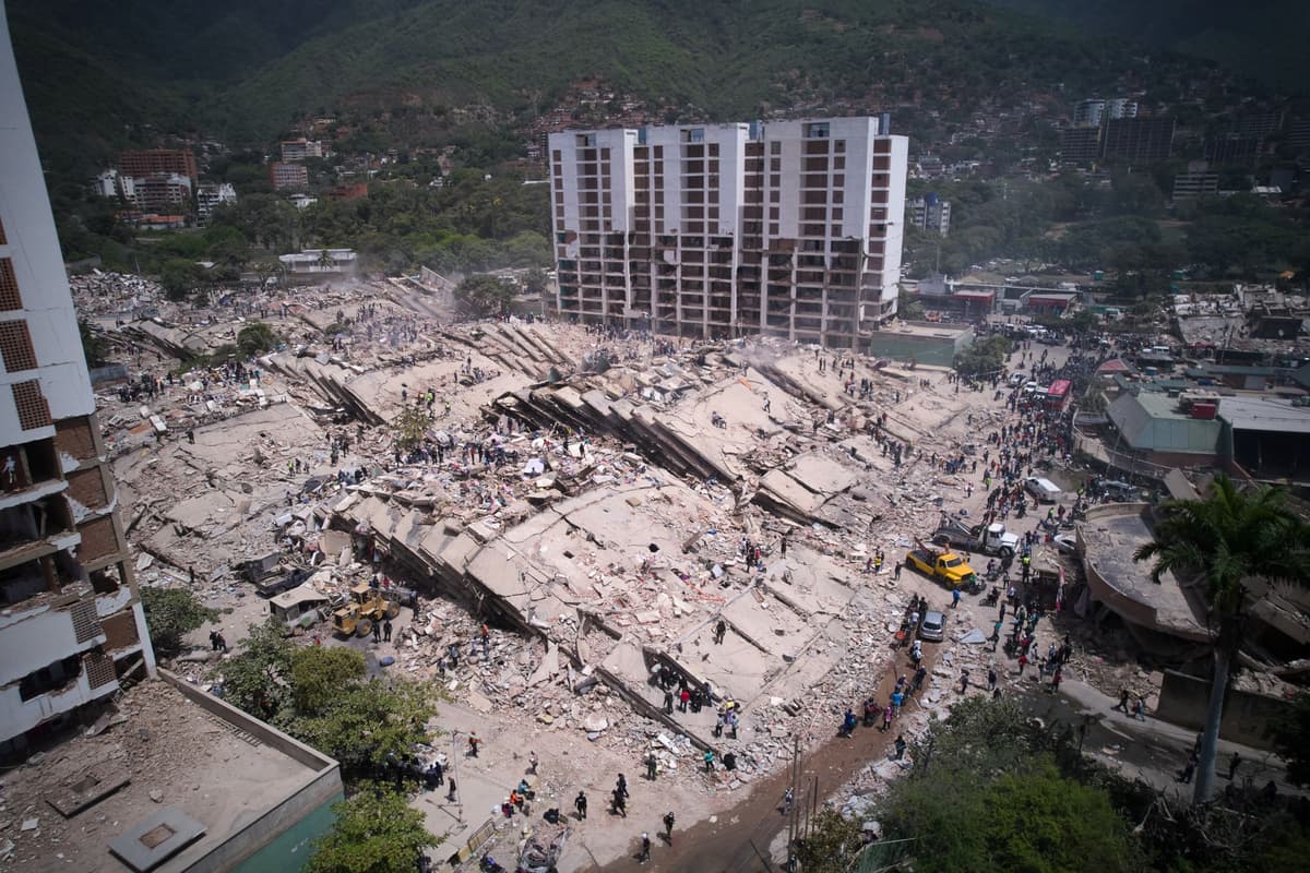Obyvatelia a záchranári prehľadávajú trosky zrútených obytných budov po stredajšom silnom zemetrasení vo venezuelskom meste Catia la Mar 26. Foto: TASR/AP